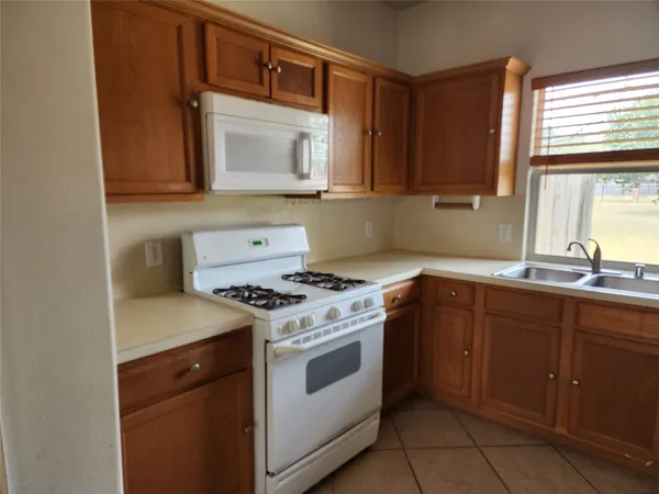 a kitchen with a stove microwave and sink