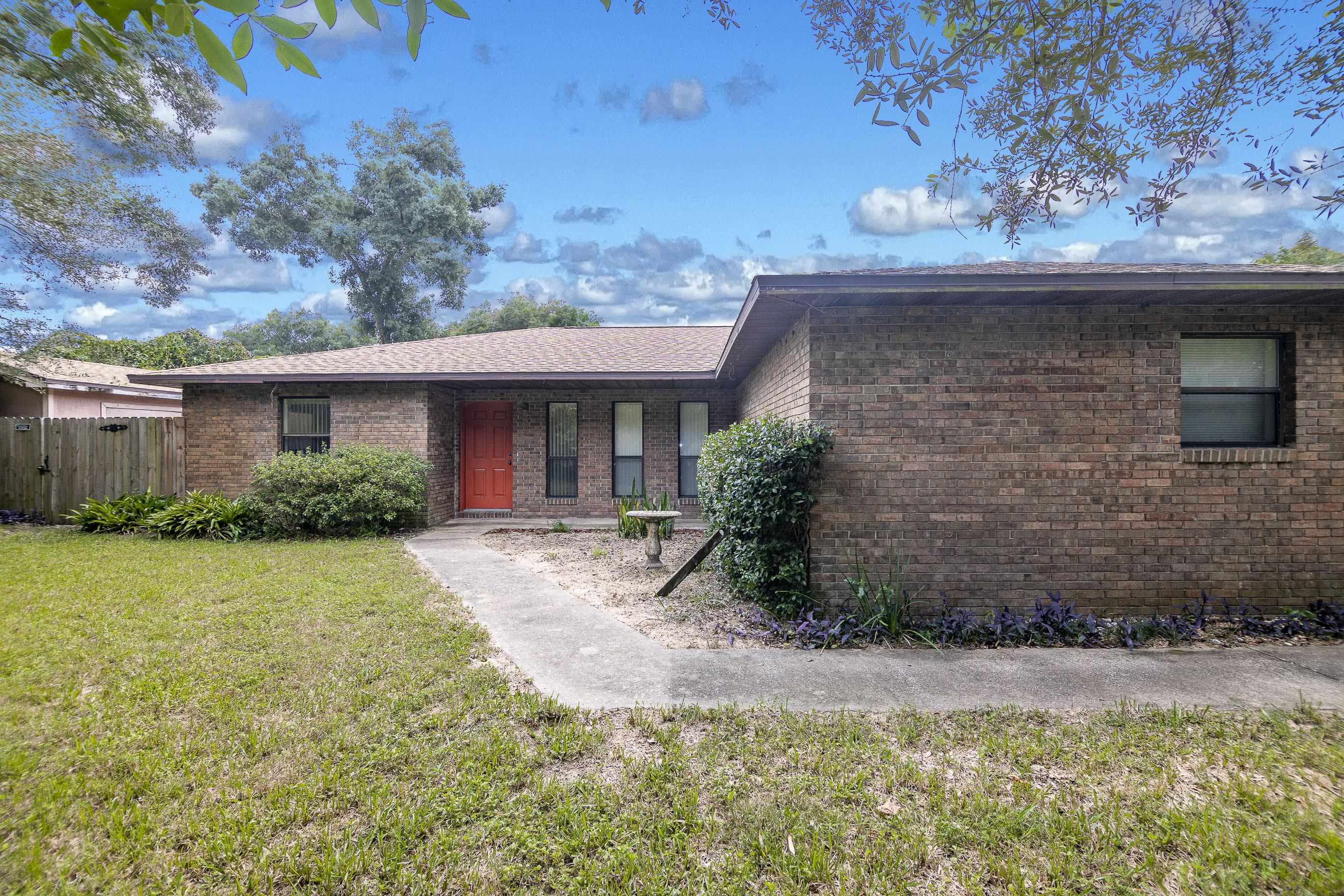 303 Cypress Road St. Augustine, FL 32086 - Photo 1 of 33 a front view of a house with garden