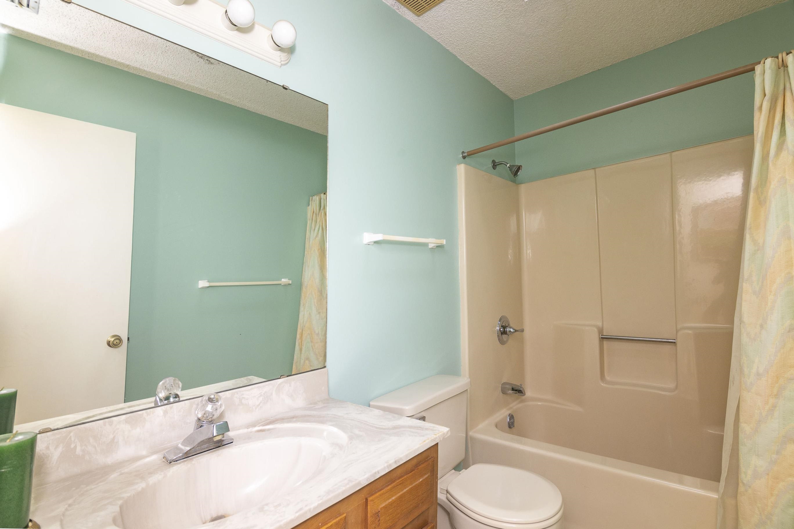 303 Cypress Road St. Augustine, FL 32086 - Photo 18 of 33 a bathroom with a granite countertop sink toilet and shower