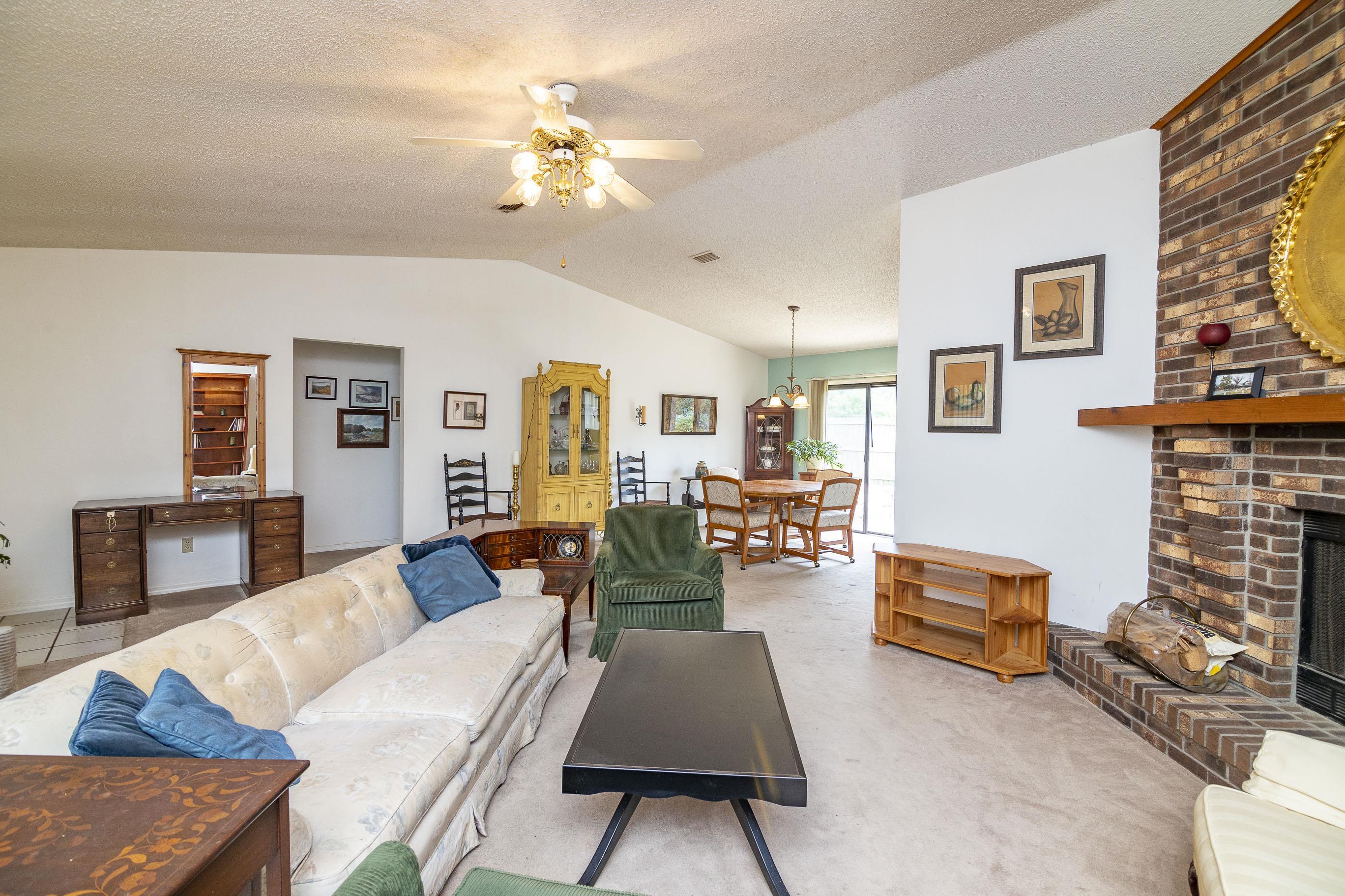 303 Cypress Road St. Augustine, FL 32086 - Photo 21 of 33 a living room with fireplace furniture and a chandelier