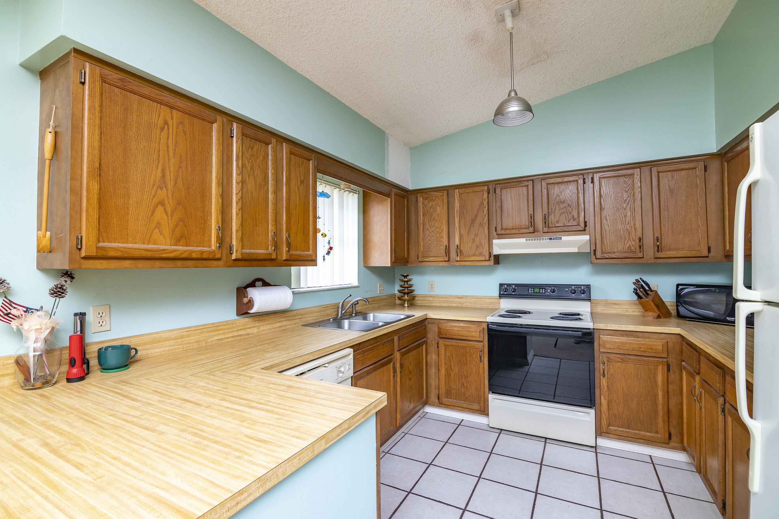 303 Cypress Road St. Augustine, FL 32086 - Photo 24 of 33 a kitchen with stainless steel appliances granite countertop a sink counter space cabinets and a window