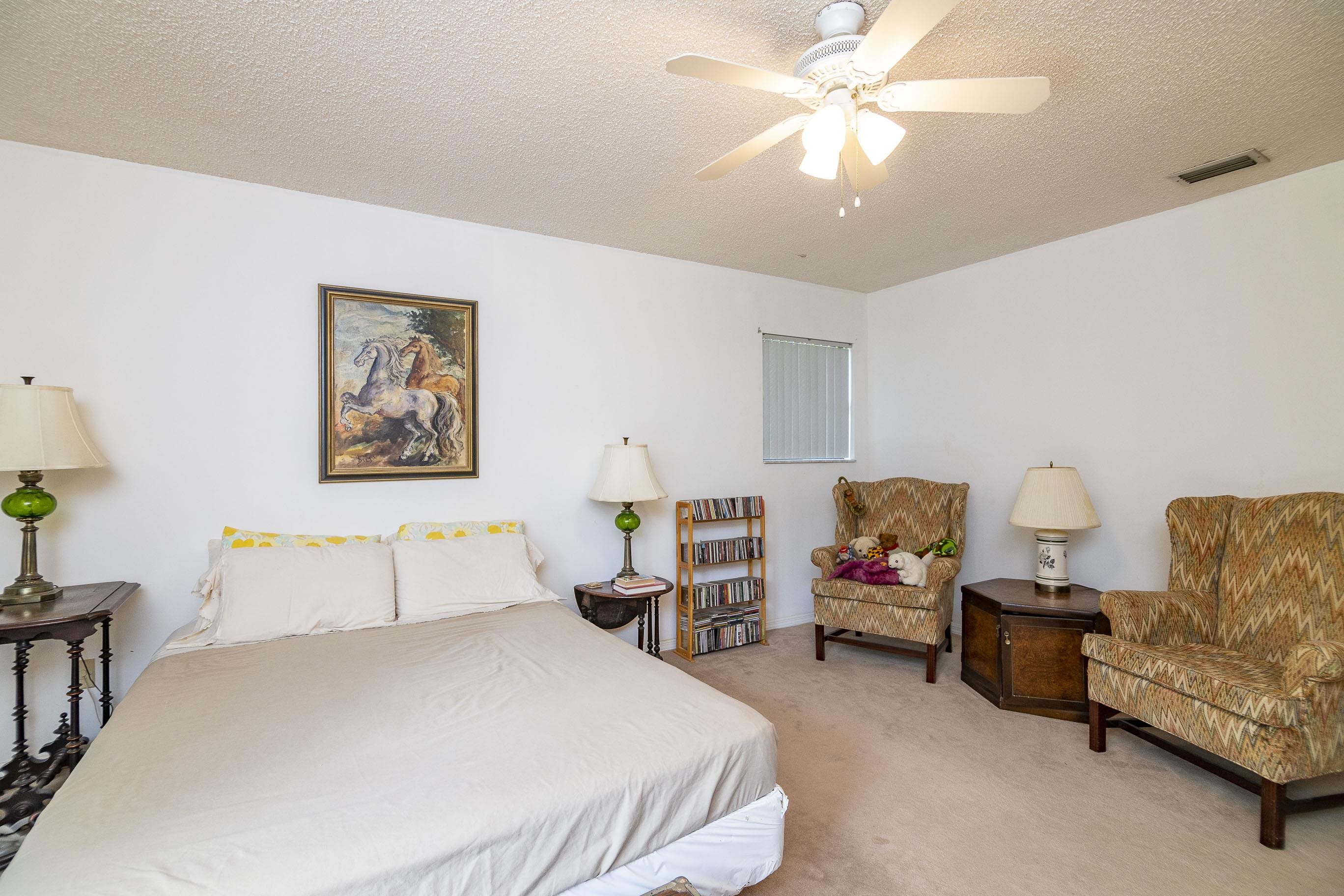 303 Cypress Road St. Augustine, FL 32086 - Photo 28 of 33 a bedroom with bed and a chandelier