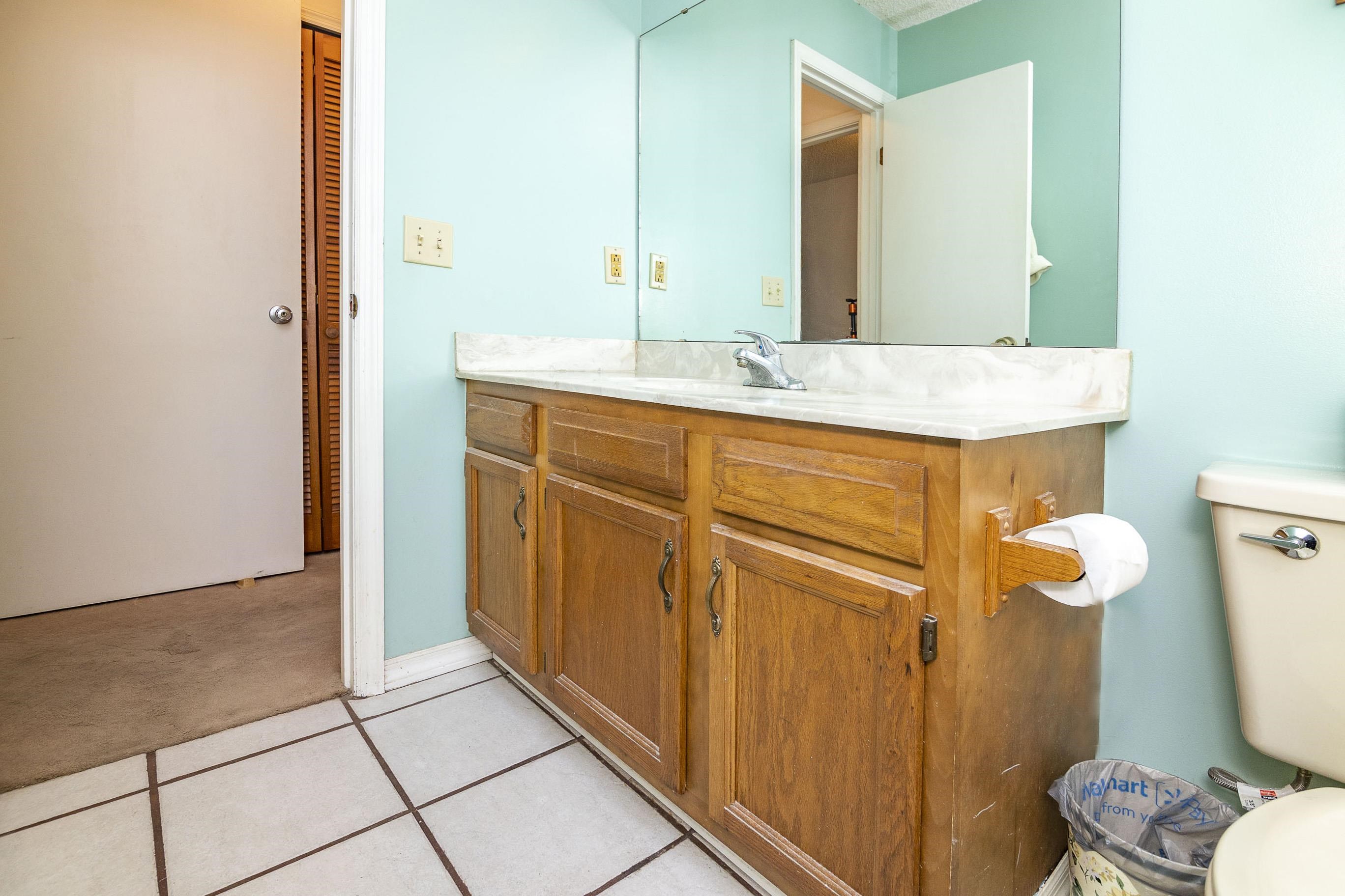 303 Cypress Road St. Augustine, FL 32086 - Photo 32 of 33 a bathroom with a sink a toilet and mirror