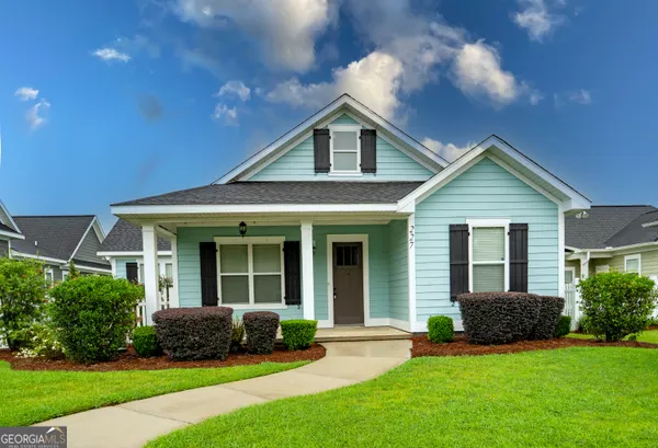 a front view of a house with a yard