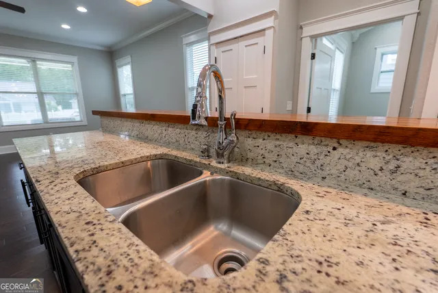 a kitchen with stainless steel appliances kitchen island granite countertop a stove a refrigerator and a microwave