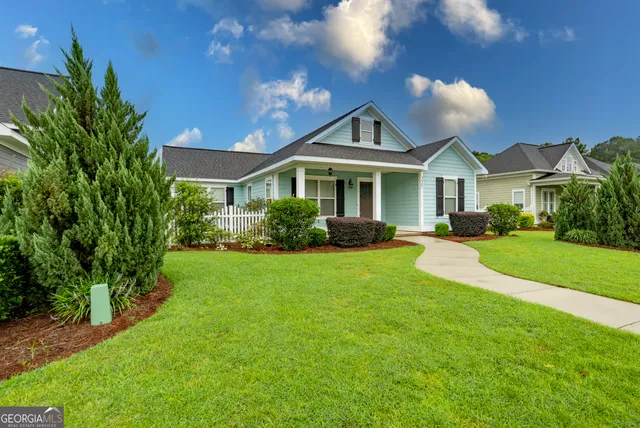 a front view of a house with a garden