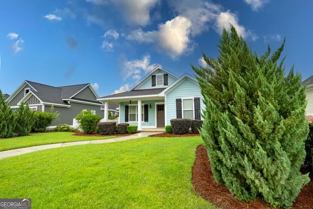 a front view of a house with a yard and porch