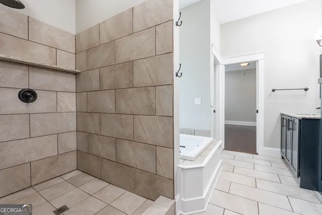 a bath room with a sink a toilet and a mirror