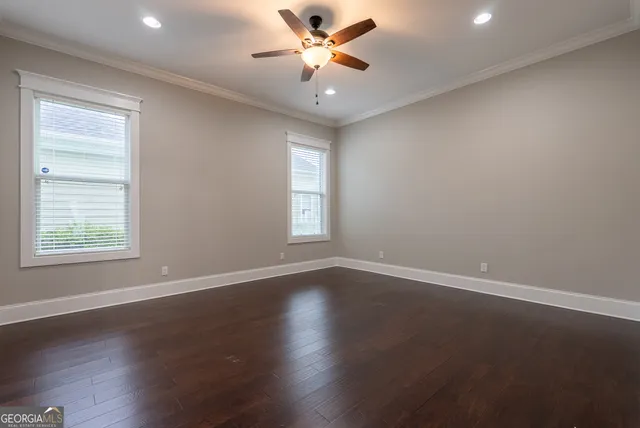 a view of a hallway with wooden floor and closet area