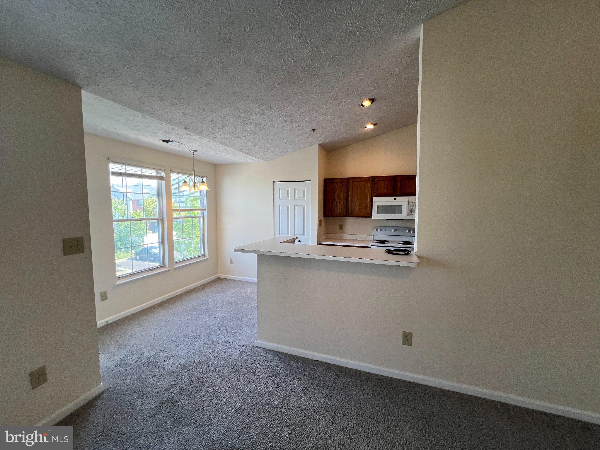 703 Orchard Overlook, Unit 301 Odenton, MD 21113 - Photo 8 of 28 Bright and airy open living space.