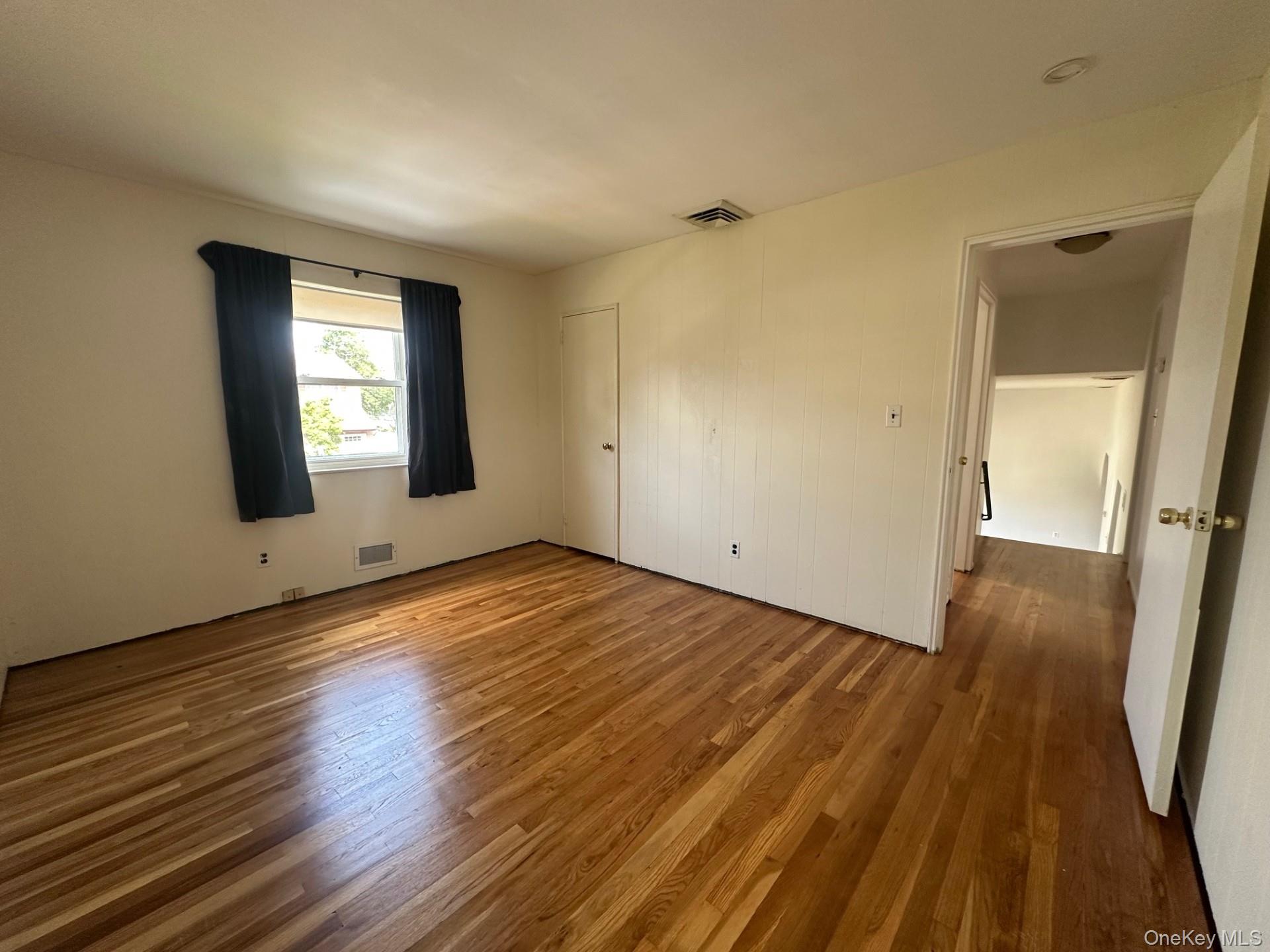 103 Wayne Street Jericho, NY 11753 - Photo 11 of 14 a view of a room with wooden floor and brick walls