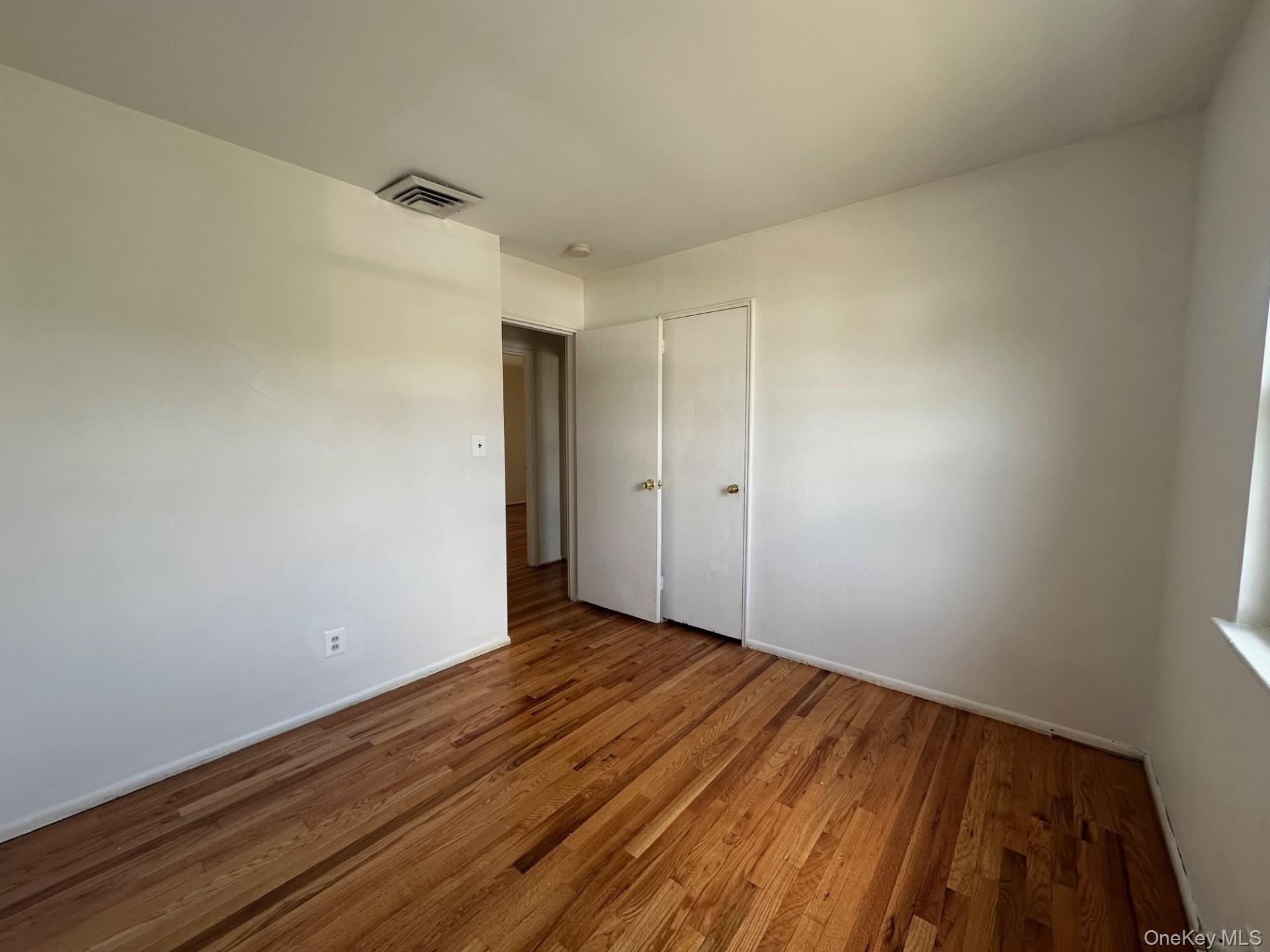 103 Wayne Street Jericho, NY 11753 - Photo 13 of 14 a view of room with wooden floor