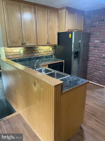 a kitchen with stainless steel appliances granite countertop a refrigerator and a stove