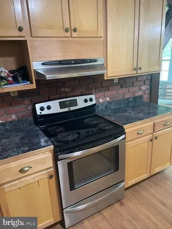 a stove top oven sitting inside of a kitchen