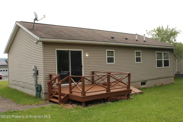 a backyard of a house with a table and chairs