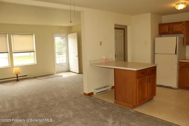 a view of a kitchen with a sink dishwasher and a refrigerator