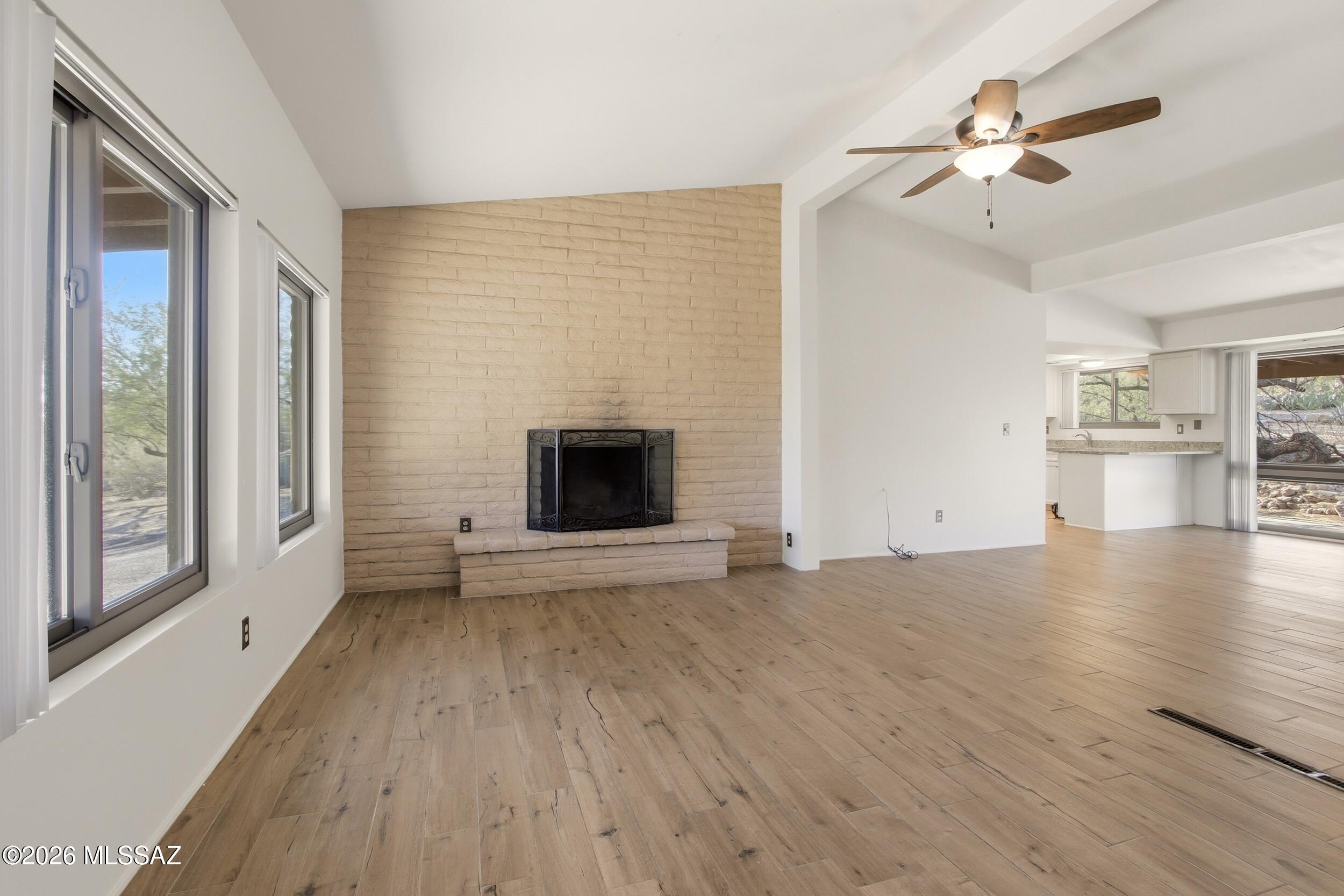 9141 East Indian Canyon Road Tucson, AZ 85749 - Photo 8 of 33 a view of empty room with wooden floor and fan
