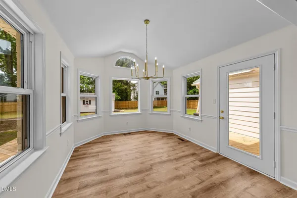an empty room with windows and outdoor view