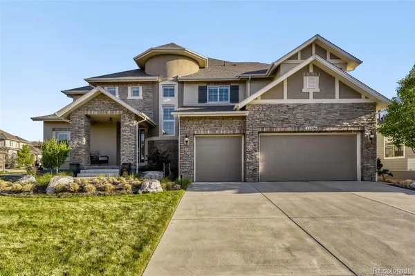 a front view of a house with yard and garage