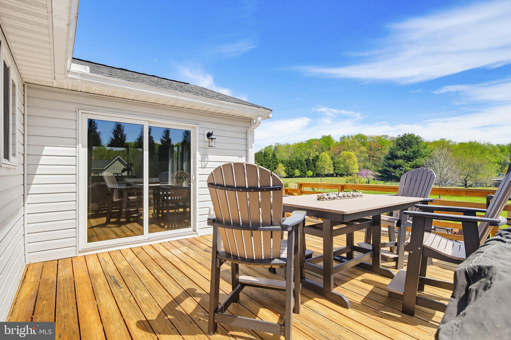 3229 Beards Point Road Davidsonville, MD 21035 - Photo 36 of 69 a view of a patio with table and chairs with wooden floor and fence