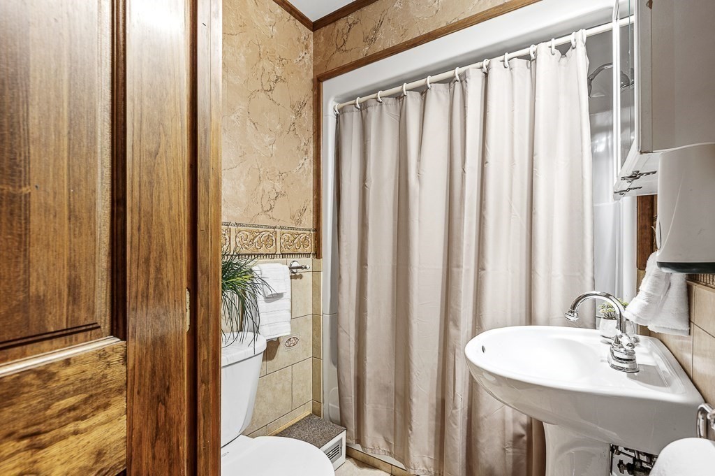 380 Quaker Street Northbridge, MA 01534 - Photo 19 of 42 a bathroom with a sink a toilet and shower curtain