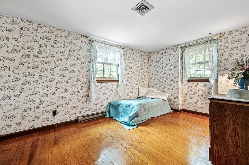 380 Quaker Street Northbridge, MA 01534 - Photo 29 of 42 a spacious bedroom with a bed and wooden floor
