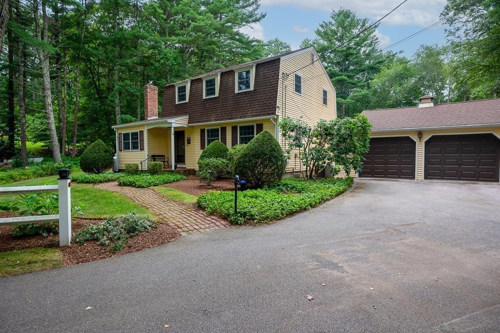 380 Quaker Street Northbridge, MA 01534 - Photo 3 of 42 a front view of a house with a garden and trees