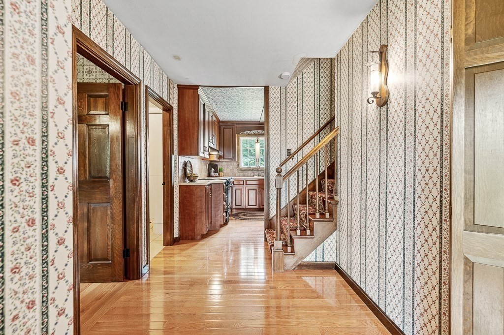 380 Quaker Street Northbridge, MA 01534 - Photo 4 of 42 a view of a hallway with wooden floor staircase and living room with wooden floor