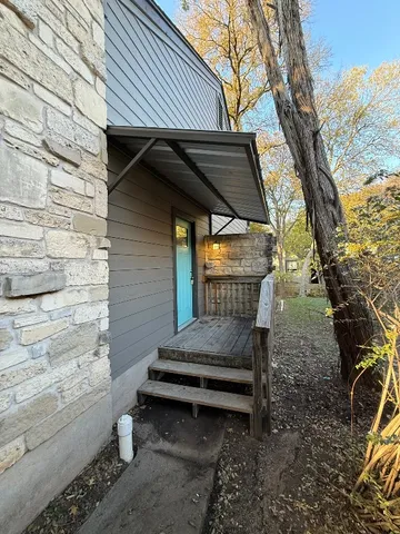 a backyard of a house with outdoor seating