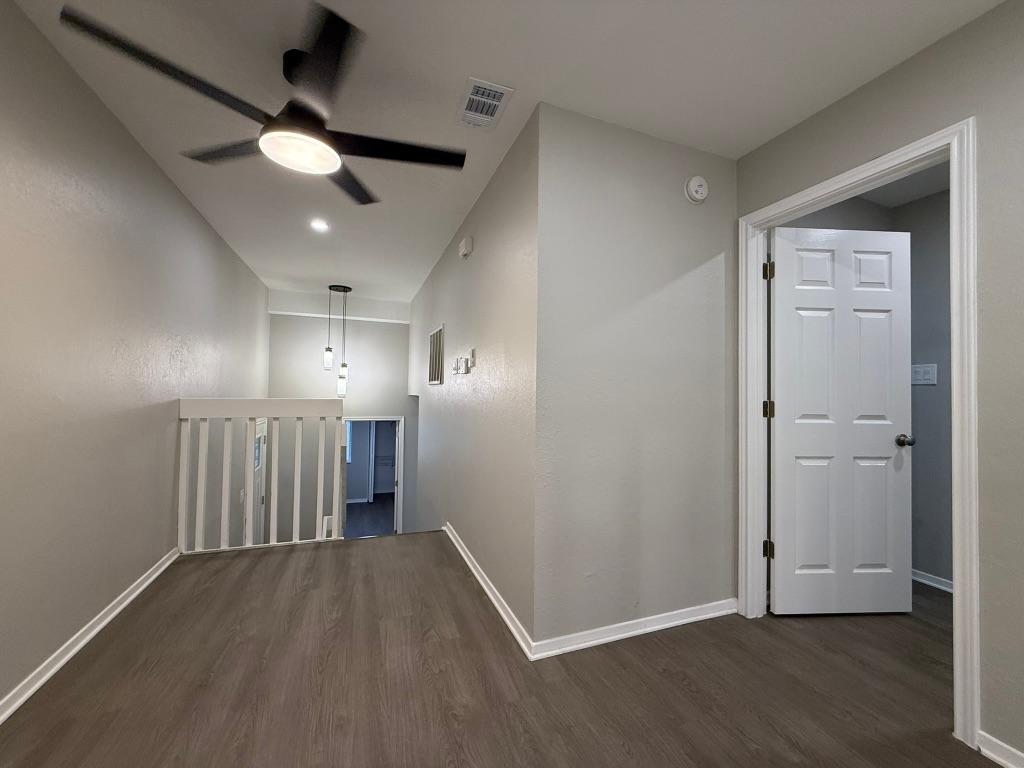 1606 Waterloo Trail, Unit A Austin, TX 78704 - Photo 11 of 17 an empty room with wooden floor and a ceiling fan