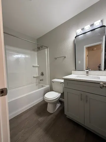 a bathroom with a sink a toilet and a large mirror