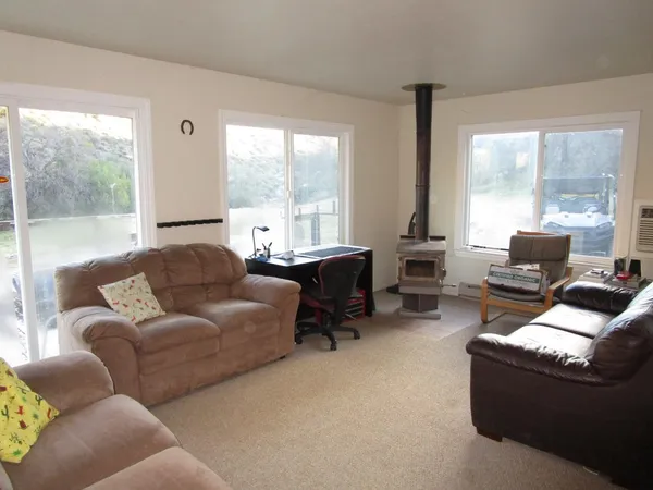 a living room with furniture and large windows