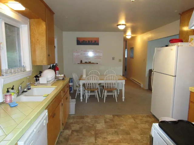 a very nice looking dining room with a dining table and a refrigerator