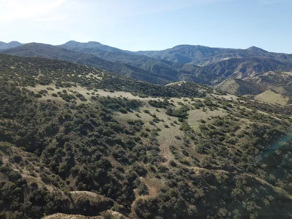 a view of a dry top and mountain in the background