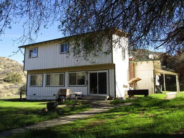 a front view of a house with a yard and porch