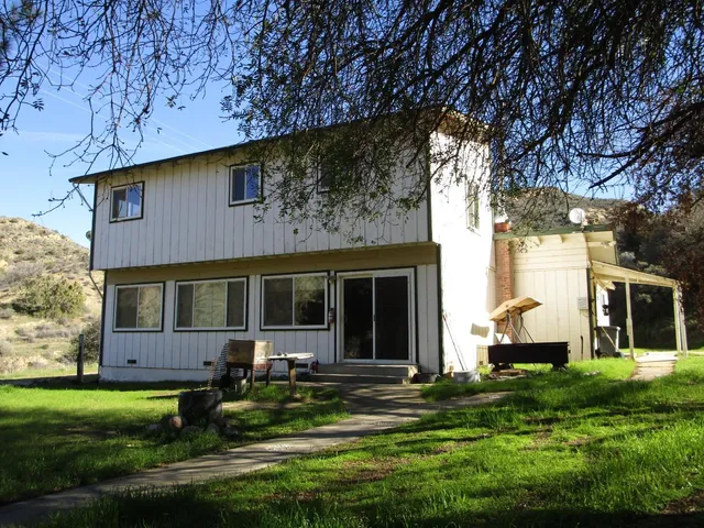 a front view of a house with a yard and porch