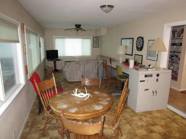 a dining room with furniture and window