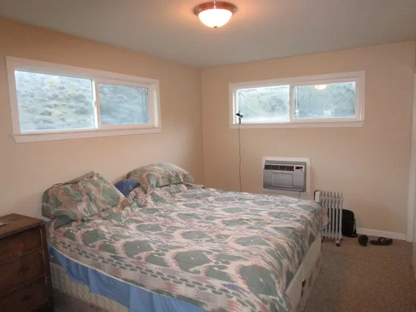 a bedroom with a bed and window