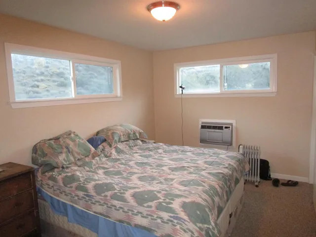 a bedroom with a bed and window