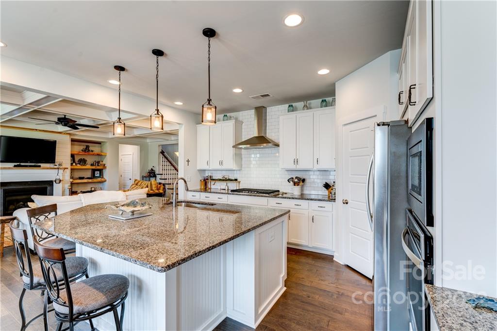 1198 Therns Ferry Drive Fort Mill, SC 29708 - Photo 11 of 48 a kitchen with stainless steel appliances granite countertop a kitchen island a stove a table and chairs
