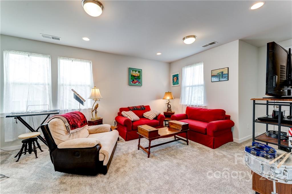1198 Therns Ferry Drive Fort Mill, SC 29708 - Photo 20 of 48 a living room with furniture and a flat screen tv