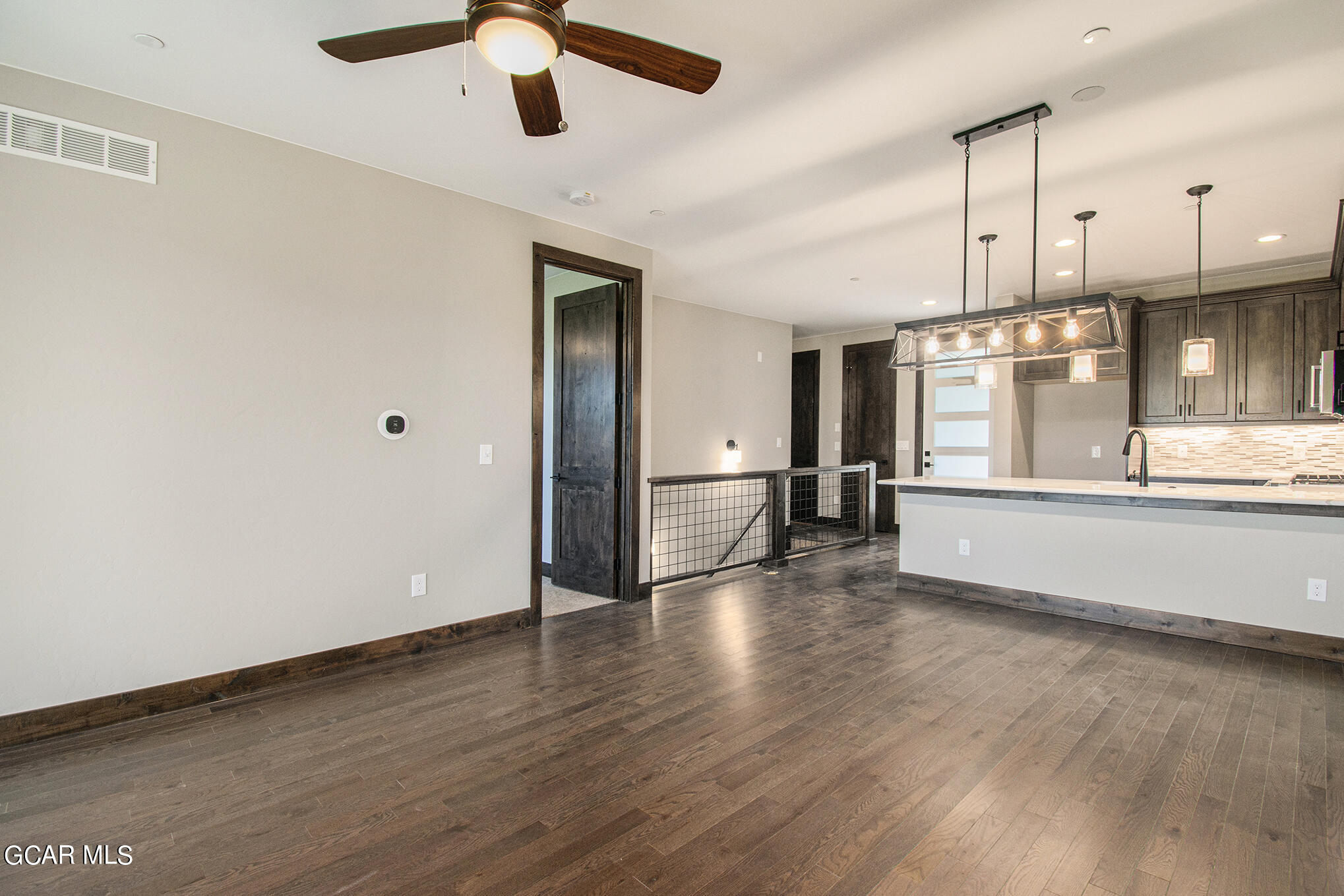 141 Homestead Loop Fraser, CO 80442 - Photo 10 of 27 wooden floor in an empty room with a kitchen