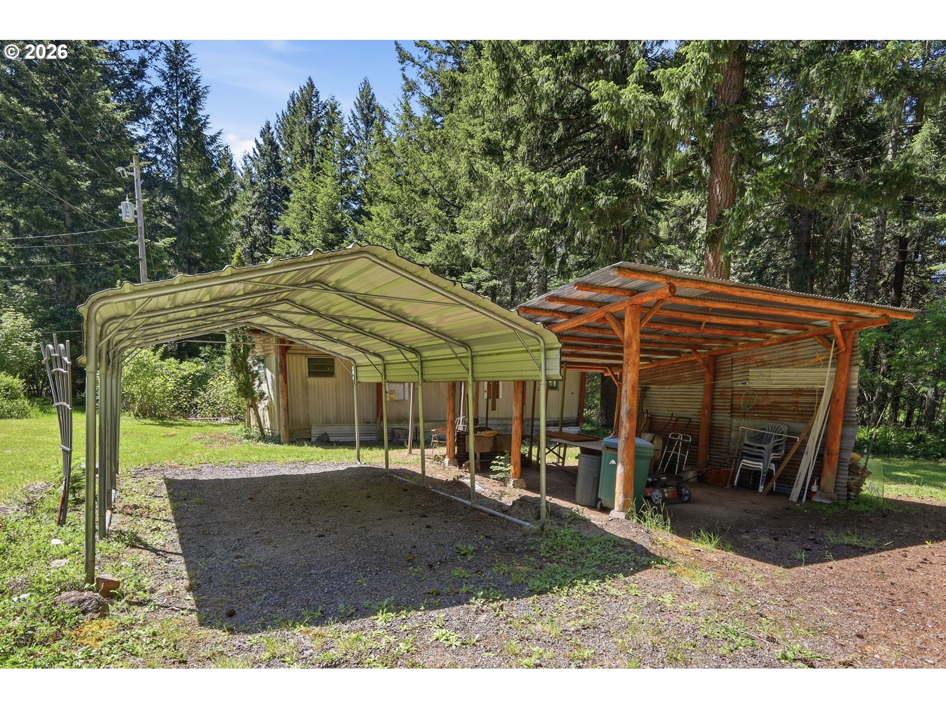 49782 Huckleberry Road Oakridge, OR 97463 - Photo 5 of 21 a view of a big house with large trees and plants