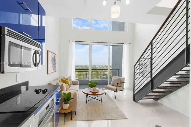 a living room with furniture and a large window