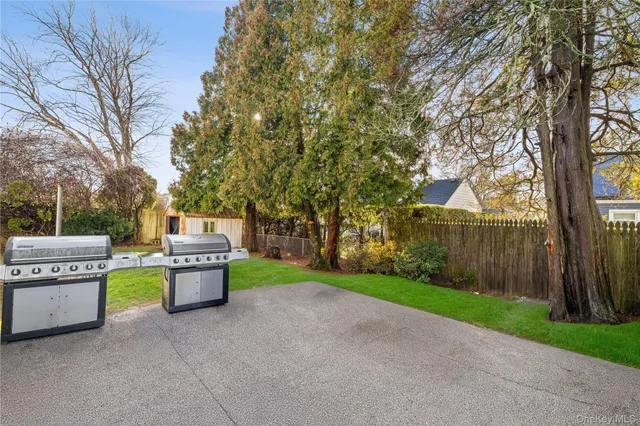 a chair and table sitting in backyard of house with trees