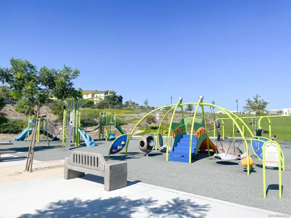 a view of a park with swings and slides