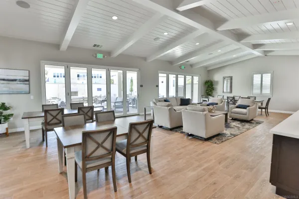 a view of a swimming pool with outdoor seating and a garden