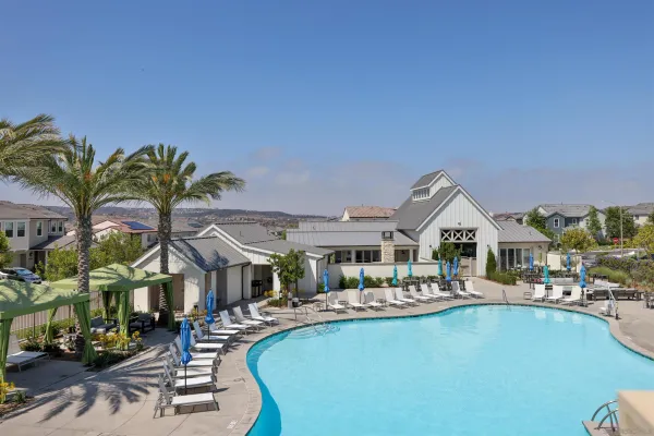 a front view of multiple houses with yard and lake view