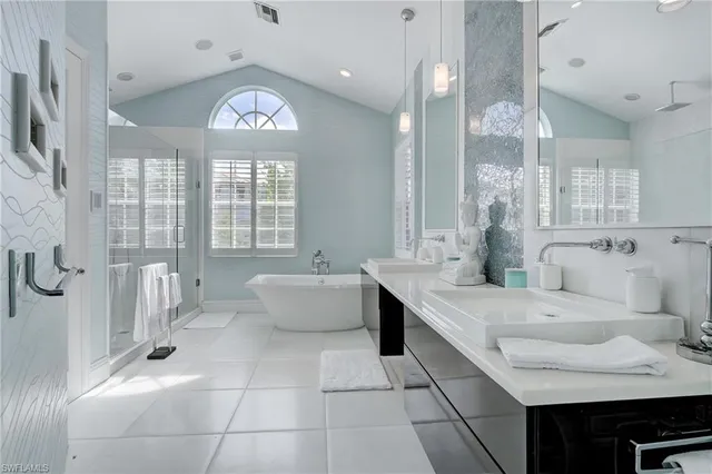 a spacious bathroom with a bathtub shower sink and mirror