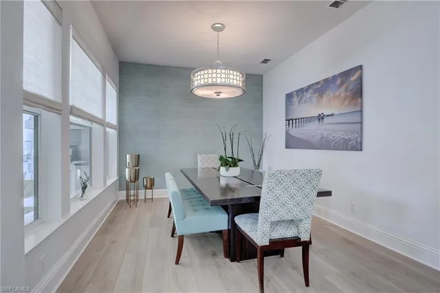 a view of a room with furniture and wooden floor